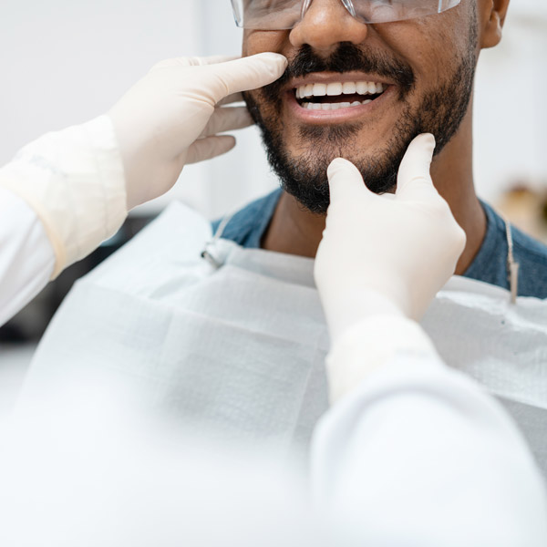 close up of dentist checking patients teeth